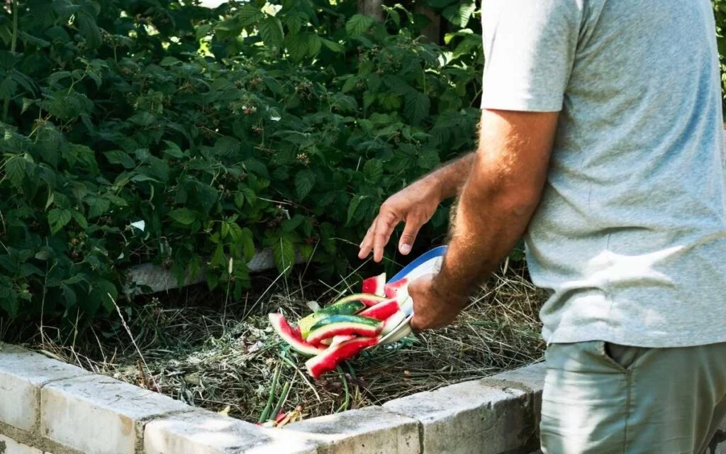 a man making a composting plant in backyard